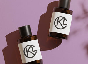 Two brown cosmetic bottles on purple background